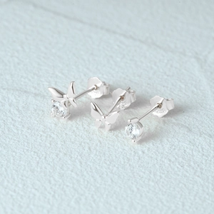 Macro detail of 925 sterling silver butterfly stud earrings with sparkling cubic zirconia