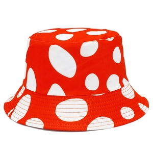 Detail of red bucket hat with white polka dots featuring high-quality stitching and fabric