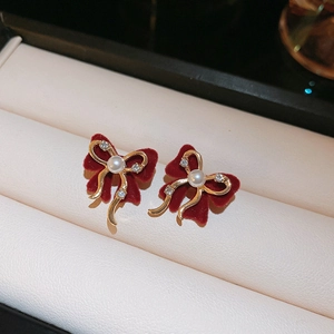 Elegant red velvet bow earrings with gold trim, center pearl, and sparkling rhinestones