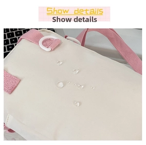 Close-up of waterproof beige fabric with water droplets and pink strap detail