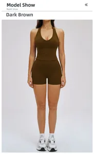 Front view of model wearing dark brown halter yoga top and high waist sports shorts