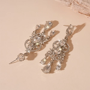 Macro shot of silver tassel drop earrings with sparkling pear and round cut crystals