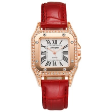 Close-up of rose gold square quartz watch with red crocodile leather strap and diamonds
