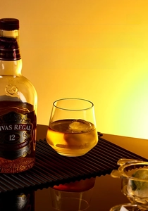 Clear ice ball in a whiskey glass with ice mold showing high quality home bar usage