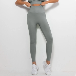 Close-up of seamless sage green yoga leggings with high-waist ribbed waistband texture