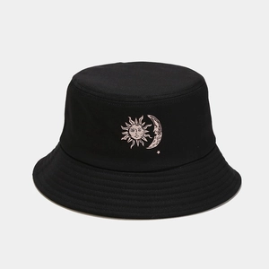 Detailed close-up of sun and moon embroidery on a black cotton fisherman bucket hat