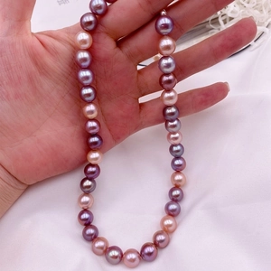 Macro detail of large multicolor baroque freshwater pearls in pink and purple shades
