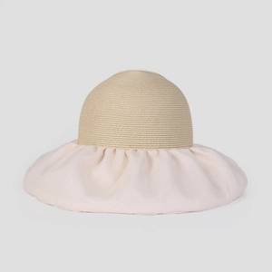 Detailed view of wide-brim sun hat with woven texture and elegant ruffled organza edge