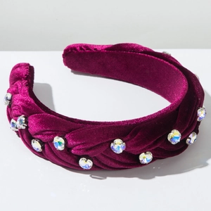 Close-up of braided purple velvet headband featuring colorful rhinestone embellishments