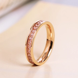 Rose gold channel-set ring featuring a full band of pink square-cut gemstones