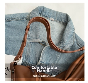 Detail view of brown leather tote bag showing sturdy silver metal rings and stitching