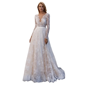 Elegant white lace long sleeve bridal gown with deep V-neck and satin waistband