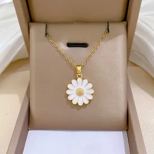 Elegant gold titanium daisy necklace with white enamel petals in a luxury jewelry box