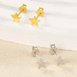 Detailed view of gold and silver star stud earrings with 925 sterling silver hallmarks