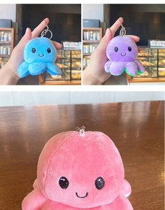 Close-up of colorful reversible plush octopus keychains in blue, purple and pink