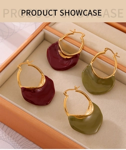 Detail view of French vintage enamel hoop earrings in burgundy and olive green