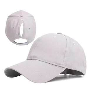 Detail of adjustable Velcro strap and ponytail hole on grey baseball cap
