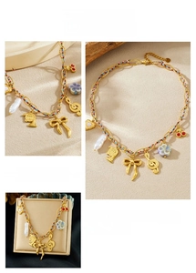 Detail of gold-plated music note and bow charms on a colorful woven chain necklace