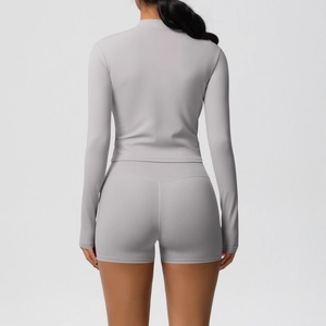 Detail view of high-waist fitness shorts with V-shaped seam for lifting effect in light purple