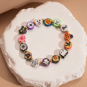 Macro shot of colorful polymer clay beads with Halloween pumpkin and ghost charms