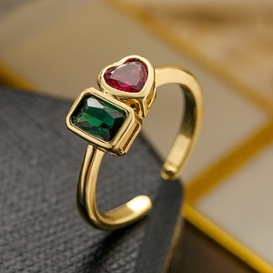Detail of gold open ring with red heart-shaped and green rectangular zircon stones