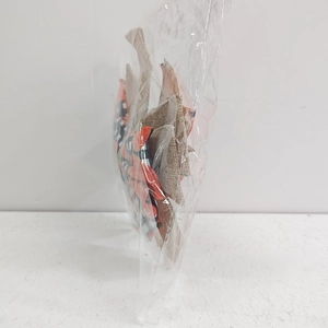Detail of a plaid pumpkin ribbon bow in orange and black linen inside plastic packaging