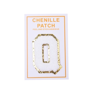 Detail of chenille letter Q patch with gold glitter border and self-adhesive backing