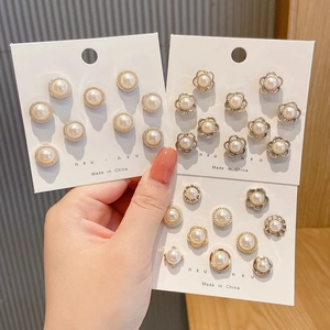 Elegant pearl brooch pin set with vintage metal frames on display cards for shirts