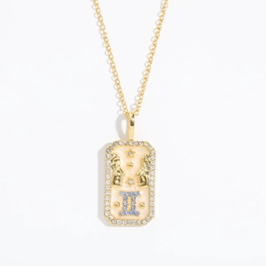 Macro shot of rectangular Gemini pendant with blue symbol and sparkling rhinestones