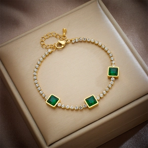 Gold chain bracelet with three emerald-cut green stones and white zircon accents