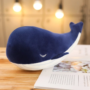 Detail of cute blue whale plush toy with fine embroidery and soft velvet fabric