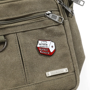 Macro shot of milk carton pin on green canvas bag with Don't Hate Me cooler text
