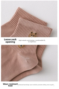 Detail of bear embroidery on breathable cotton socks with elastic ribbed cuff and thick heel