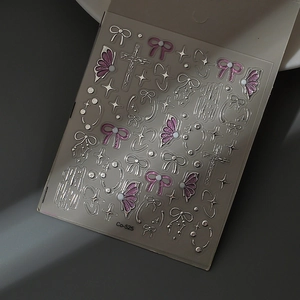Macro shot of 5D 3D silver bow and purple glitter star nail art stickers Co-525