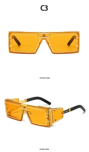 Detailed view of rectangle gold metal frame sunglasses with amber lenses and mesh temples