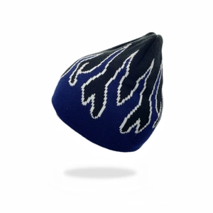 Detail of blue and black knitted beanie showing flame pattern and textured knit fabric