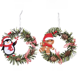 Detail of four mini Christmas wreaths with plush penguin, bear, deer and gingerbread characters