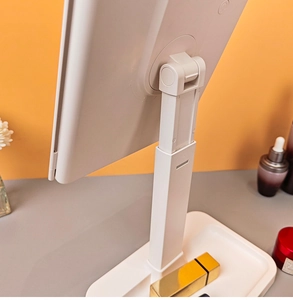 Detail view of the adjustable telescopic stand and base tray of a white LED makeup mirror