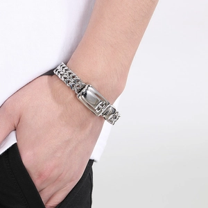 Polished stainless steel men's woven chain bracelet with sleek metallic clasp closure