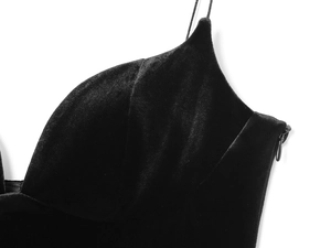 Detailed close-up of soft black velvet bodysuit with a subtle side zipper closure