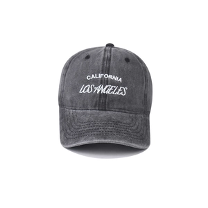 Close-up of white California Los Angeles embroidery on washed grey baseball cap