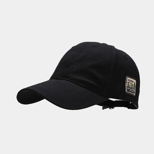 Detail of vintage patch embroidery on black cotton baseball cap with retro lettering