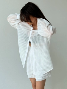 Detailed view of white vertical stripe texture on a casual summer long-sleeve shirt set