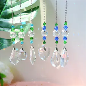 Set of 6 crystal prism pendants with blue beads creating rainbow light in sunlight