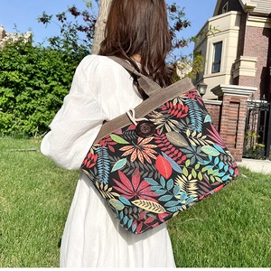 Close-up of tropical leaf print canvas tote with vintage wooden button and loop closure