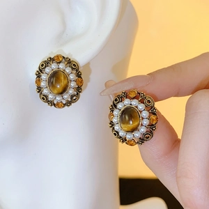 Vintage style amber stone stud earrings with pearl halo and gold-tone finish