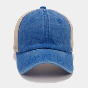 Detail of blue denim baseball cap with beige breathable mesh and reinforced stitching
