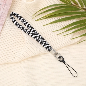 Detailed view of black and white hand-woven wrist strap with silver metal buckle and ring