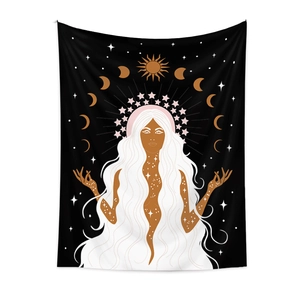 Detail of bohemian tapestry featuring a celestial goddess with sun and moon phases