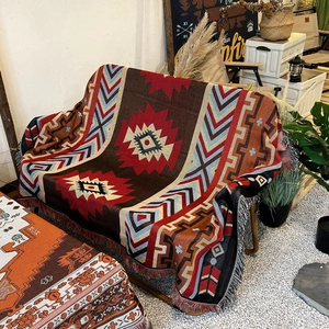 Detail of geometric camping blanket with ethnic pattern and decorative fringe edges